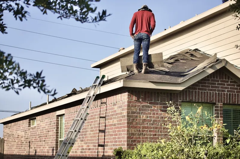 Professional roofer working on a residential roof in Pinebrook Country Club